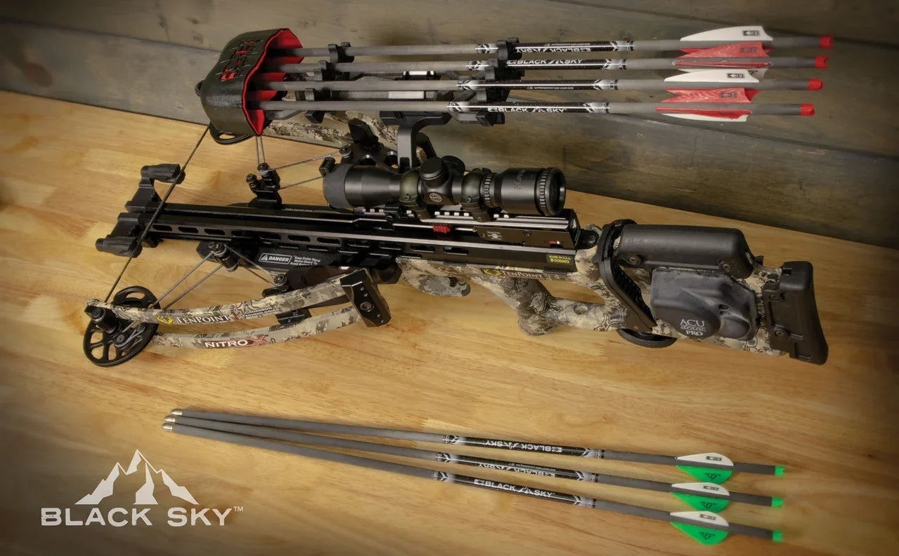 Bruin Black Sky crossbow with mounted scope, six arrows, and camouflage frame on wood table