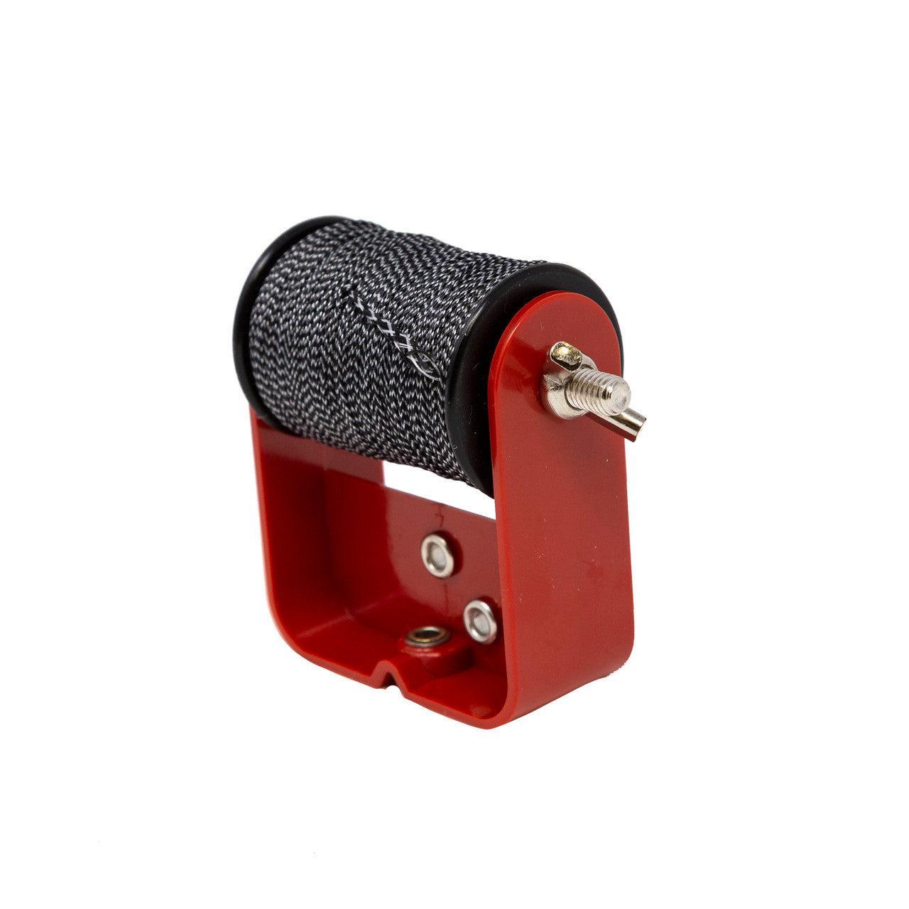 Red kite line winder with black and white braided string on white background