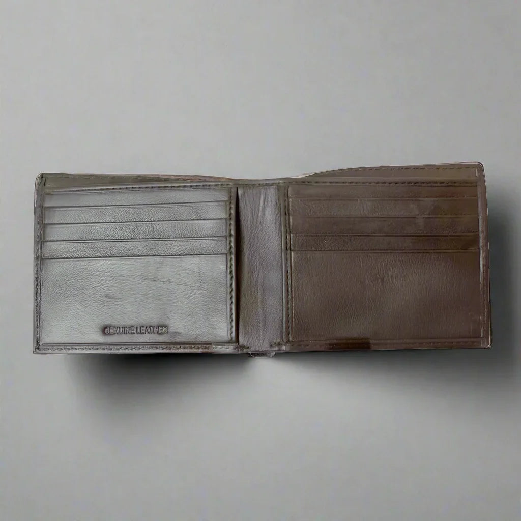 Men's bifold leather wallet open on flat surface, showing card slots and genuine leather label.