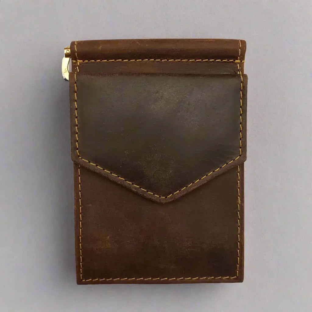 Men's distressed brown leather money clip wallet with visible stitching on a gray background