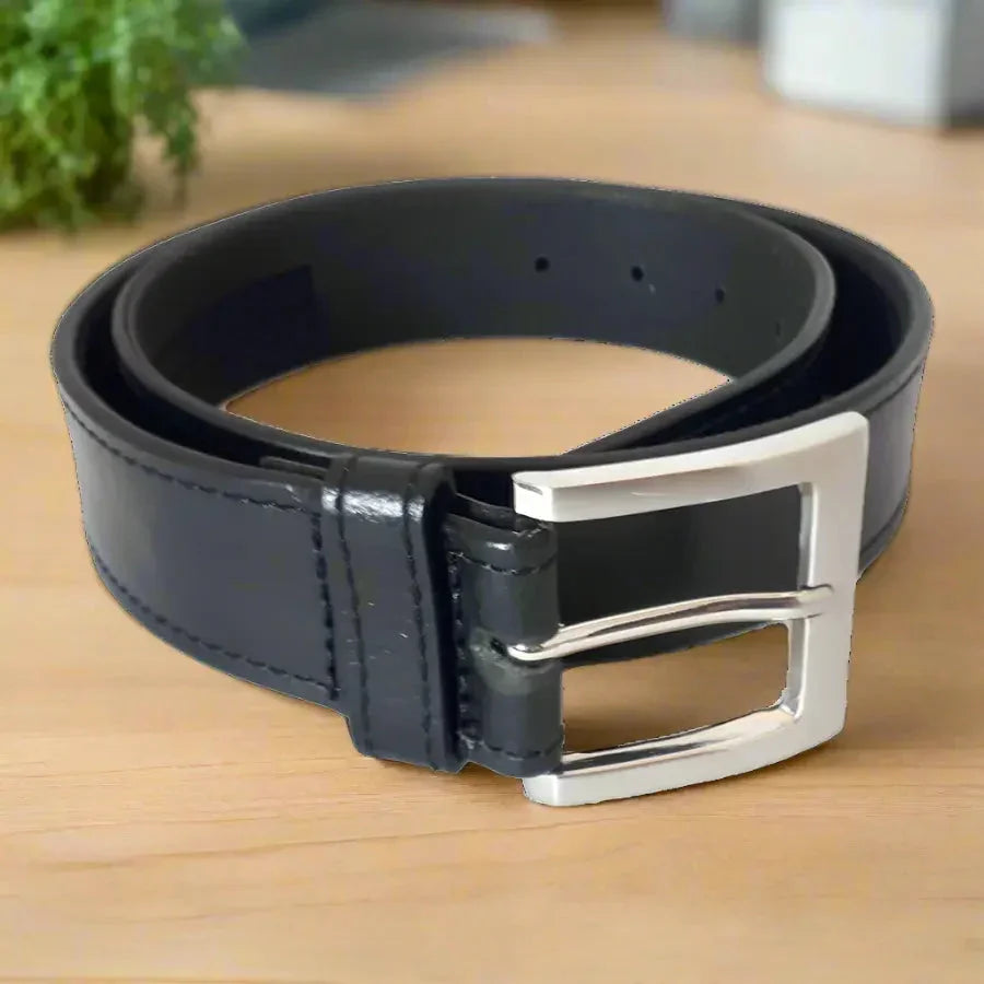 Men's black grain leather money belt with hidden pocket and silver buckle on desk