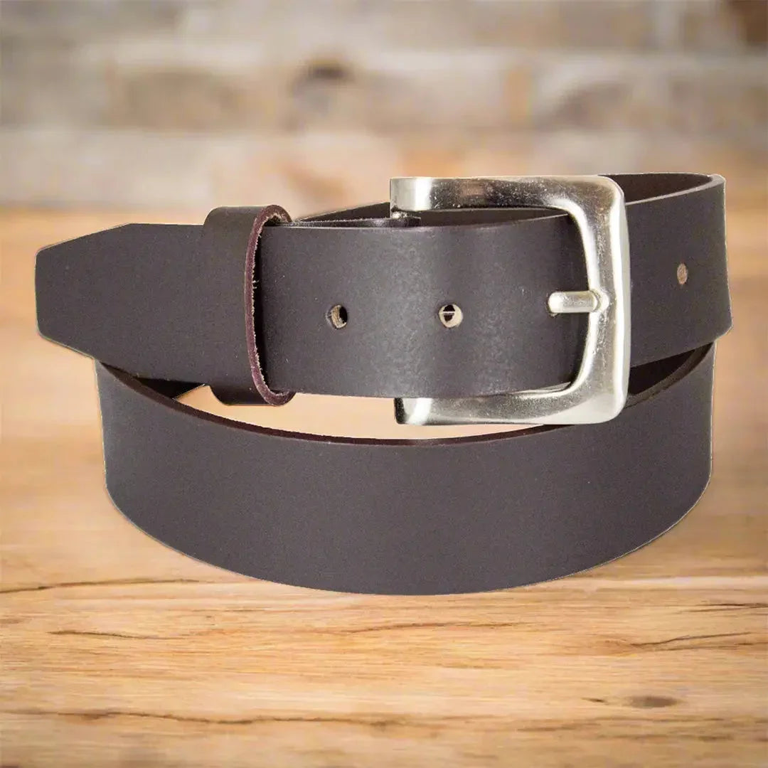 Men's dark brown smooth leather belt with silver removable buckle on wooden surface