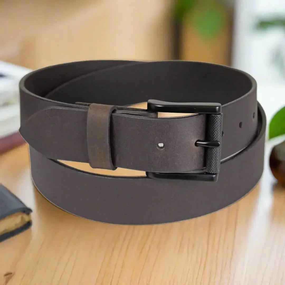 Men's solid leather belt with removable black buckle on wooden table