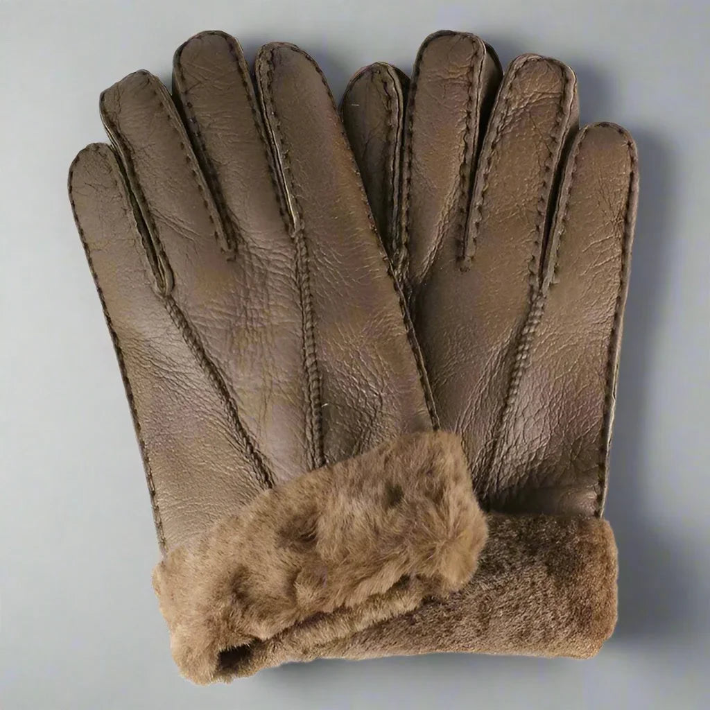 Brown men's shearling leather gloves with fur cuffs on a gray background