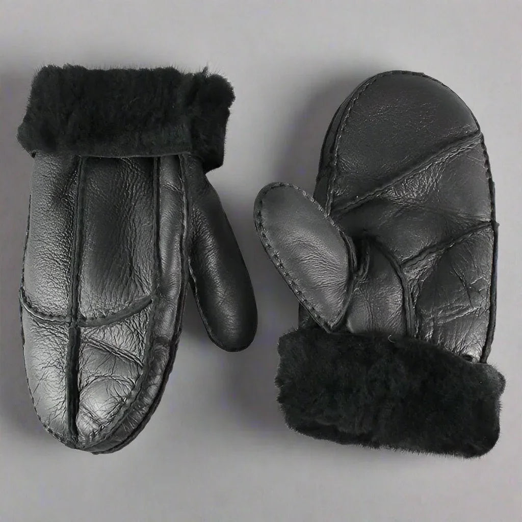 Men's black shearling leather mittens with fur cuffs on a gray background