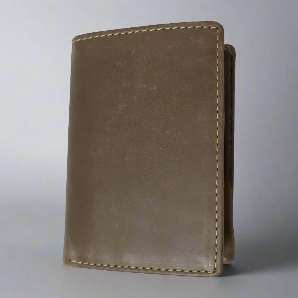 Men's trifold leather wallet in beige with visible stitching, standing upright on gray background