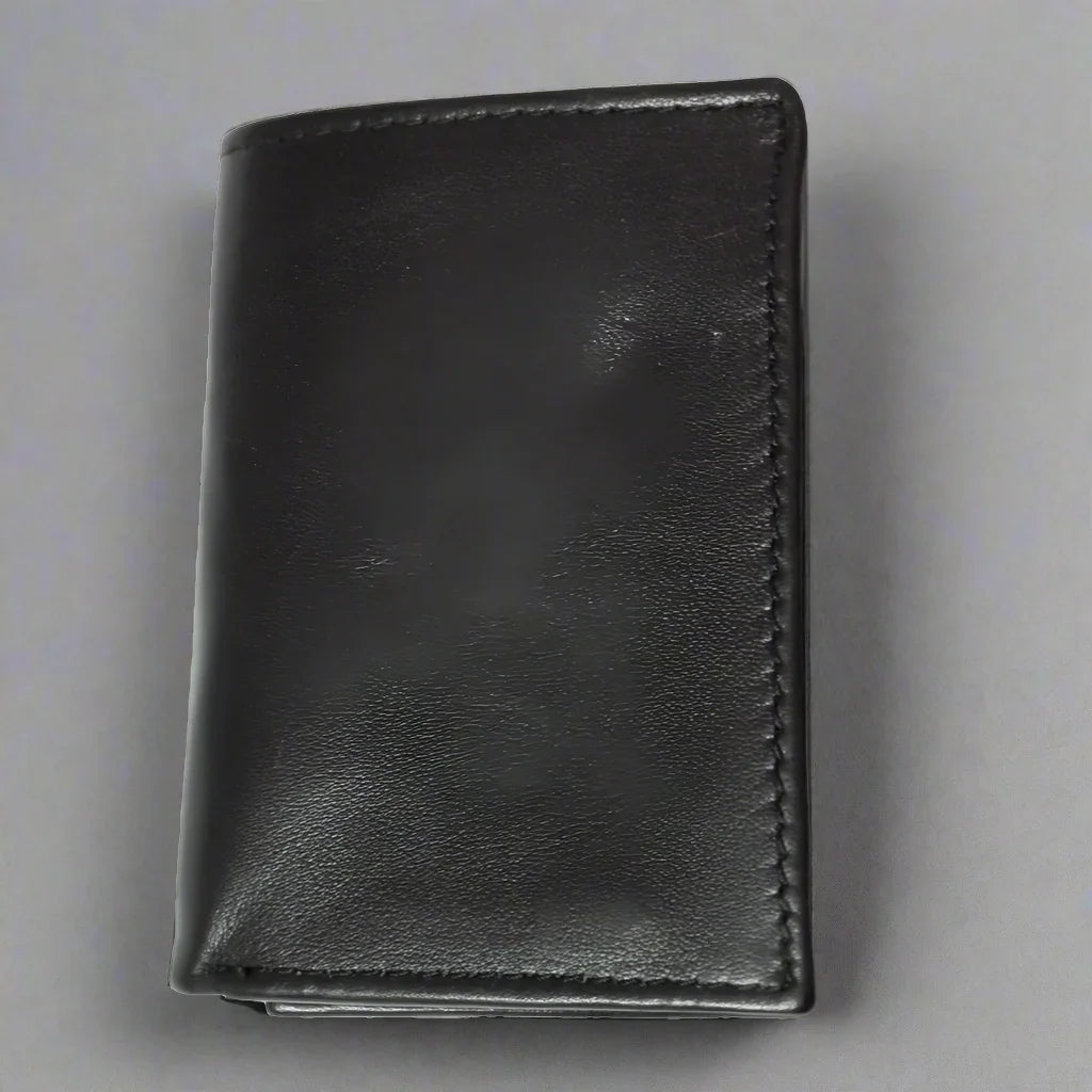 Black men's trifold leather wallet with stitched edges on a gray background