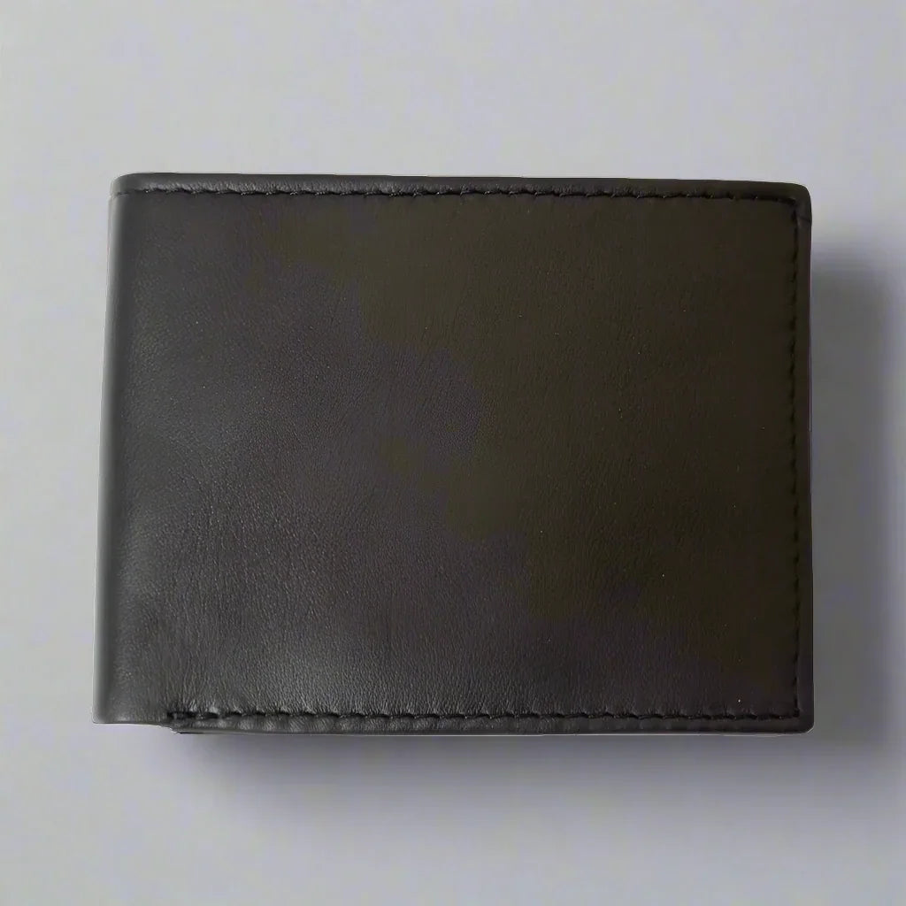 Men's black trifold leather wallet closed on a plain gray background