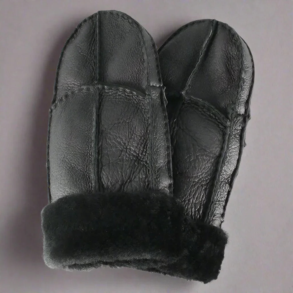 Black women's shearling leather mittens with fur cuffs on a neutral background