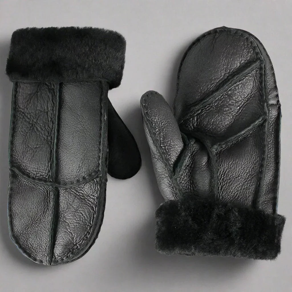 Black women's shearling leather mittens with fur cuffs on a gray background