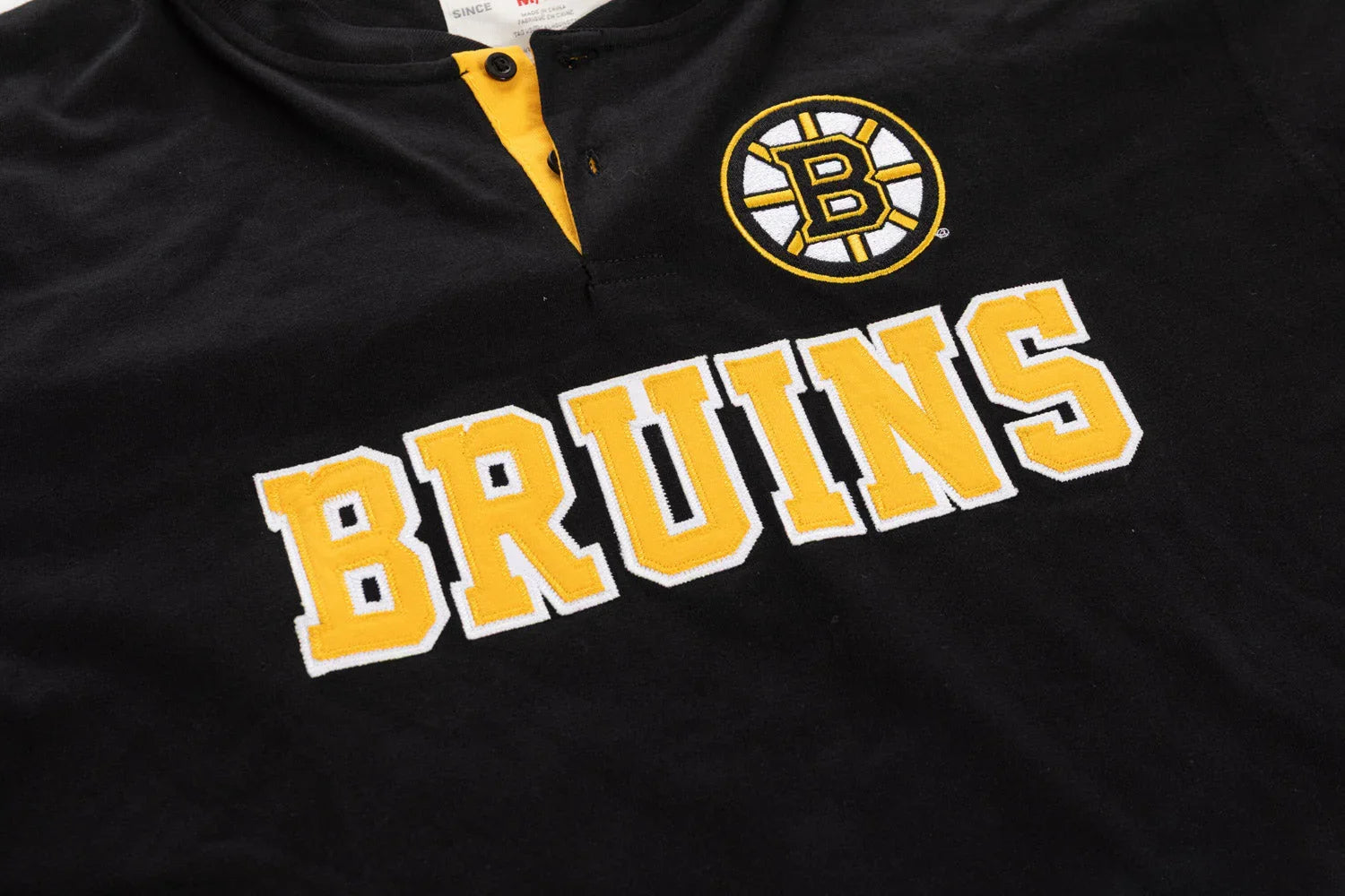 Boston Bruins black Henley shirt with yellow logo patch and BRUINS text detail