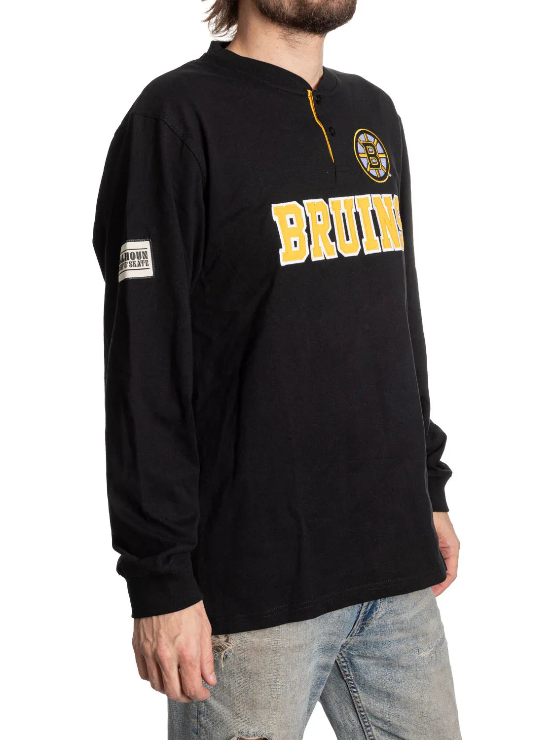 Man wearing black Boston Bruins long sleeve shirt with logo and yellow lettering