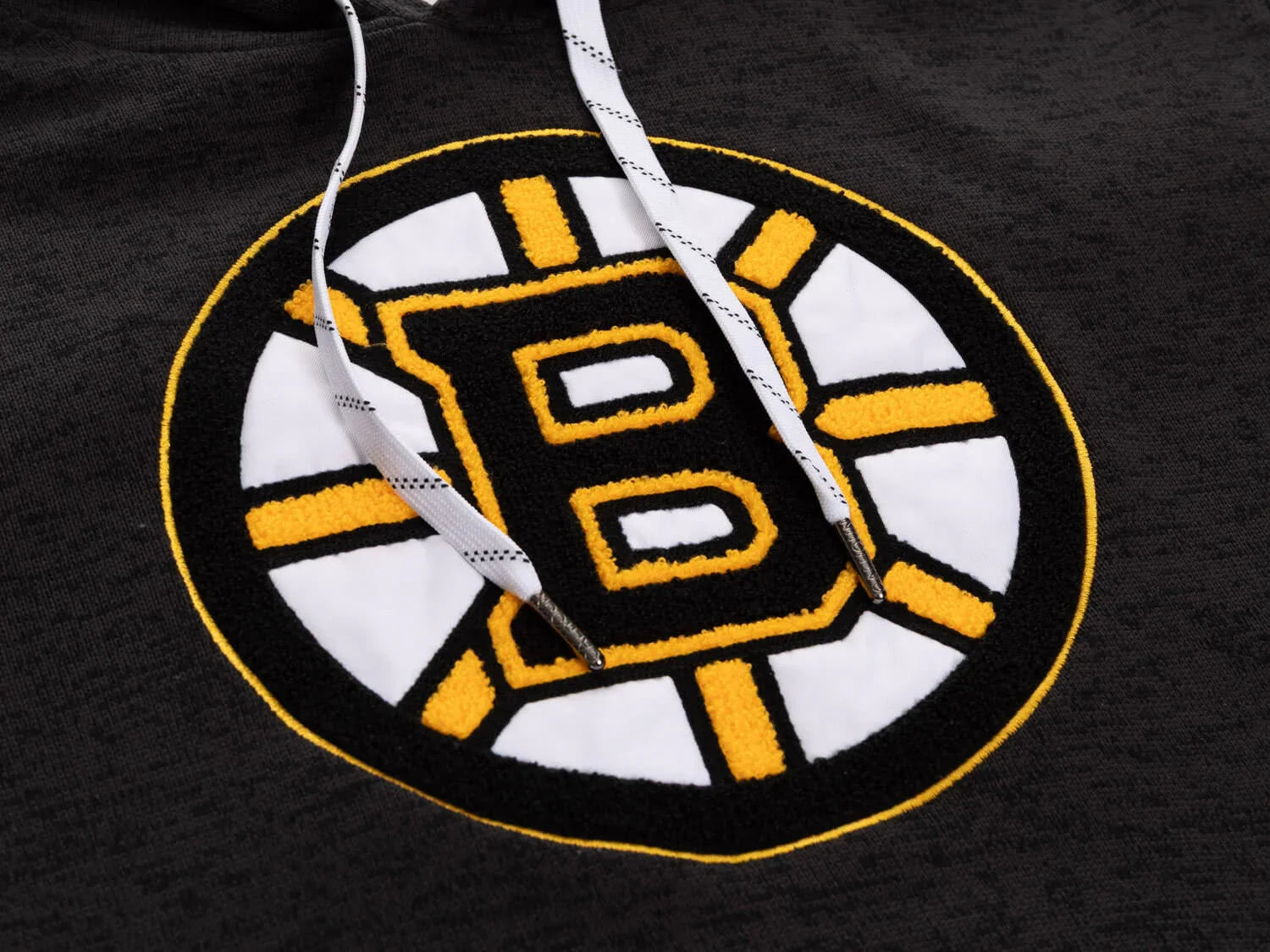 Black hoodie with detailed yellow and white embroidered hockey team logo and white drawstrings