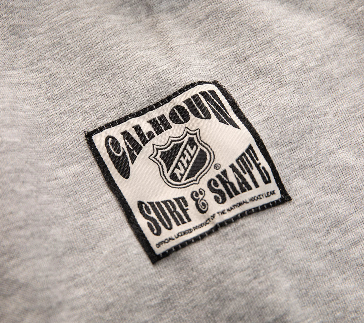 Calhoun NHL Surf & Skate patch on grey fabric, official hockey apparel label