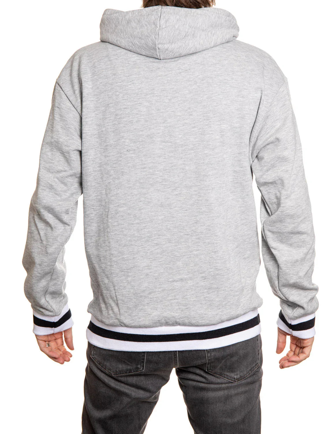 Back view of person wearing light grey hoodie and black jeans
