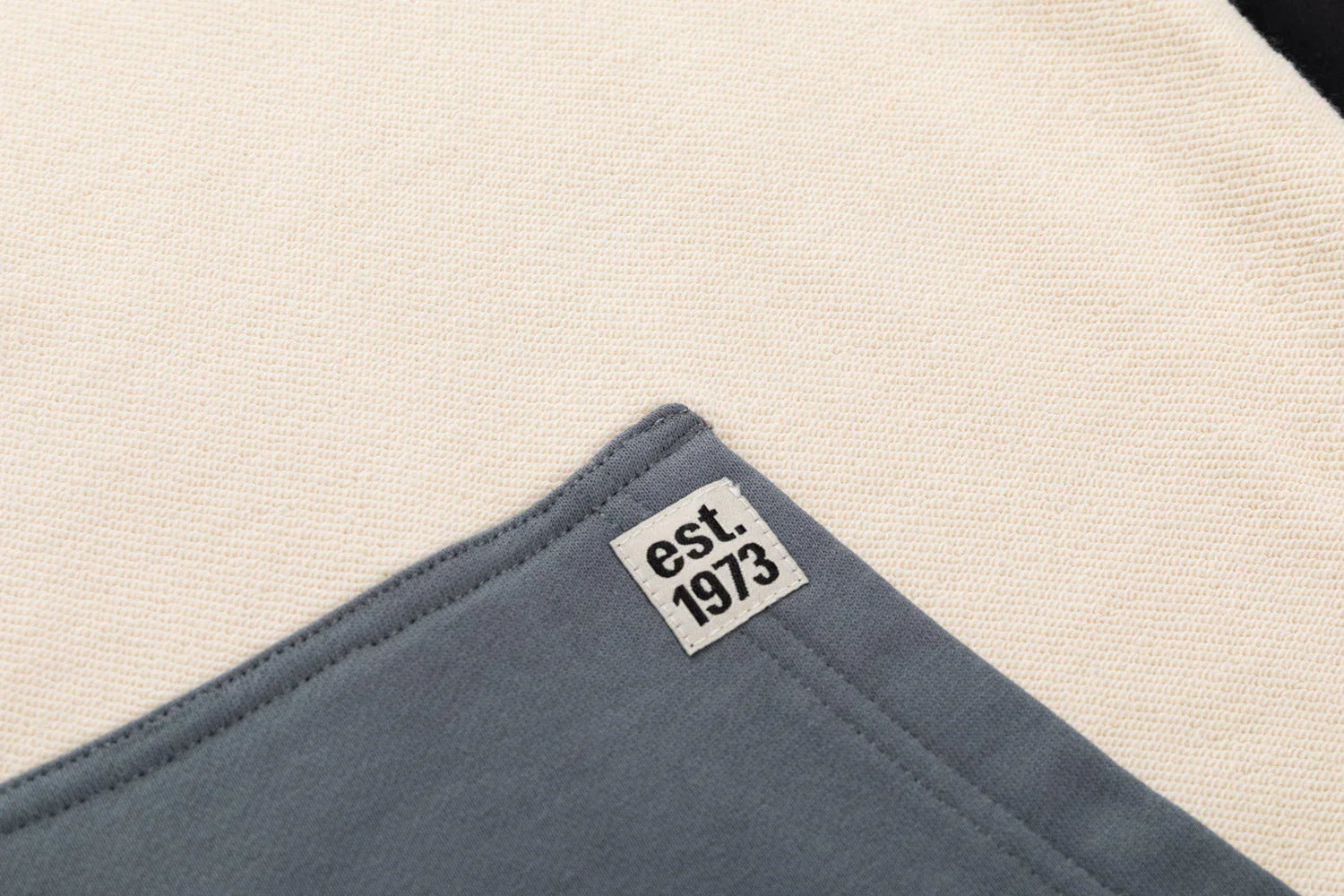 Closeup of Boston Bruins hoodie fabric with est. 1973 patch detail