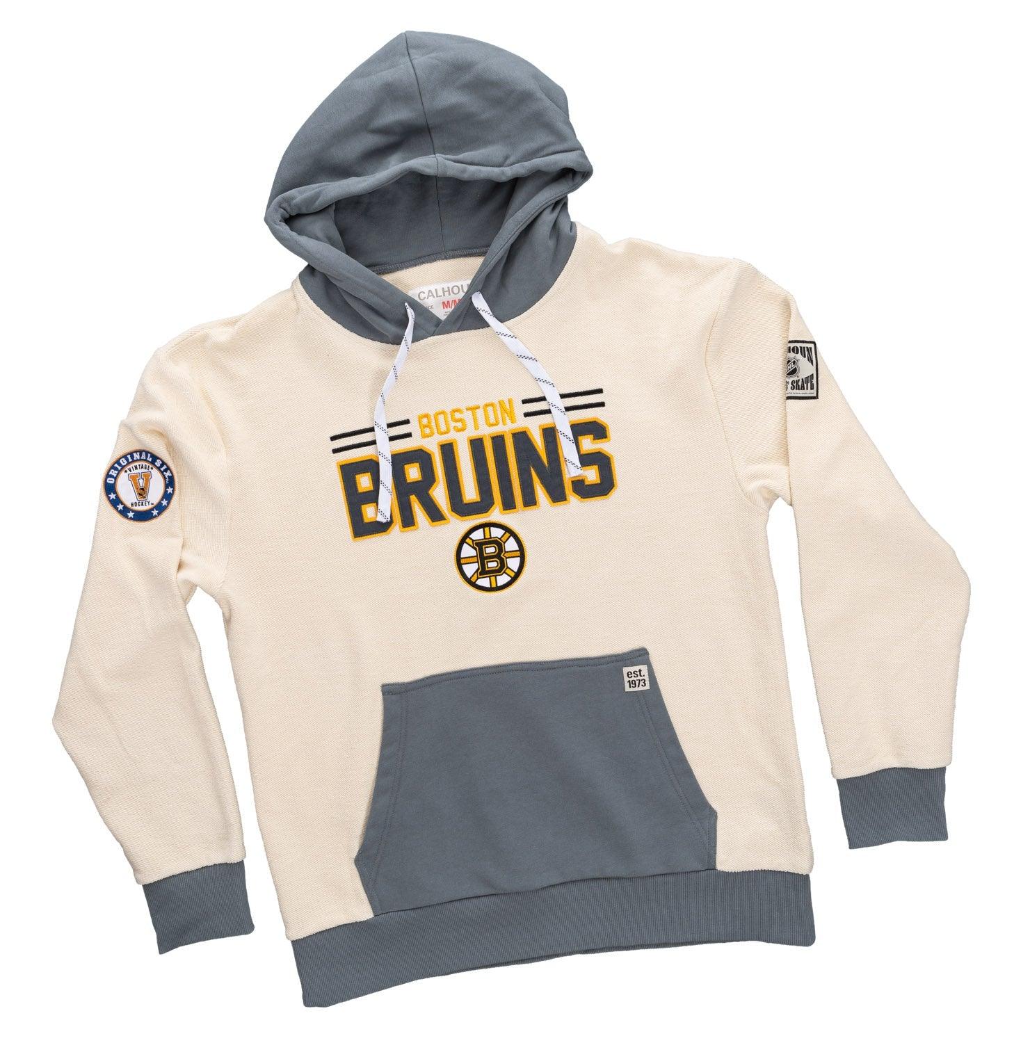 Boston Bruins cream and gray reverse hoodie with team logo and patches, flat lay