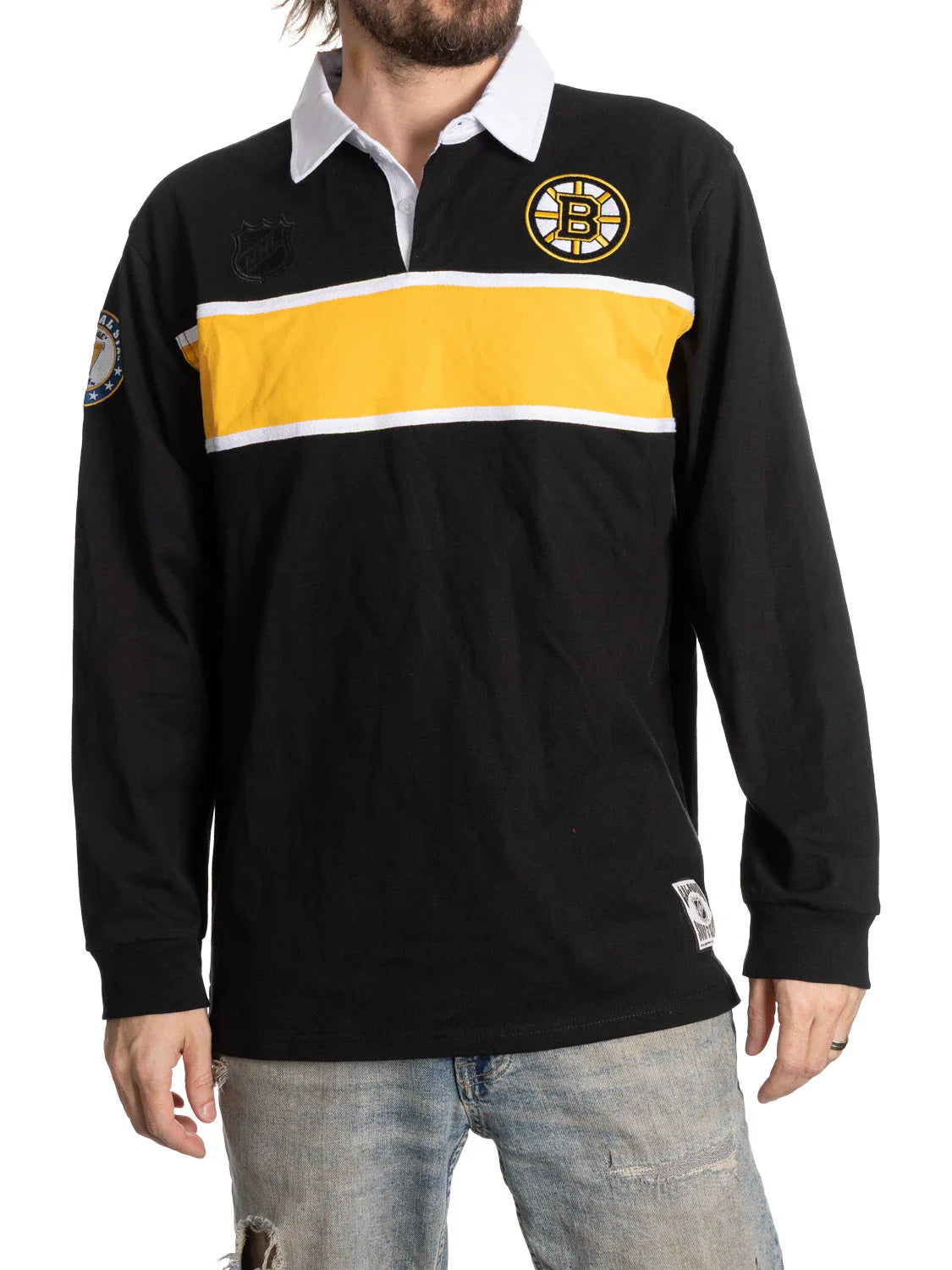 Man wearing Boston Bruins rugby shirt with yellow stripe and NHL logo, casual outfit