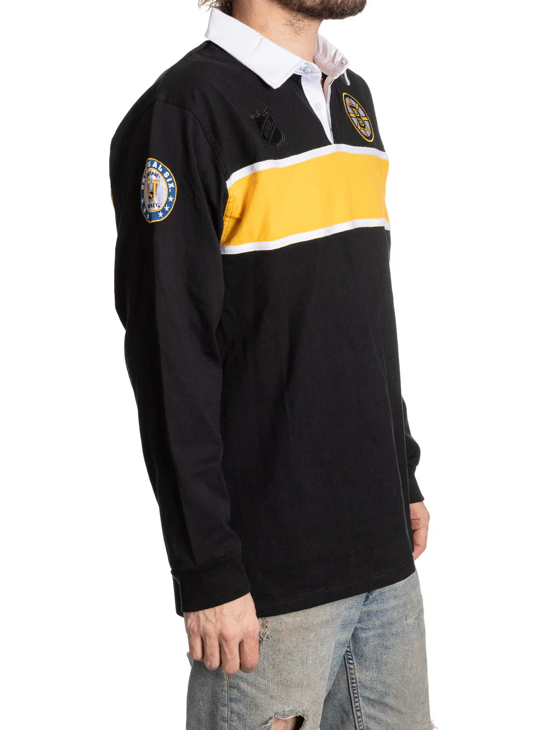 Man wearing black Boston Bruins rugby shirt with yellow stripe and white collar