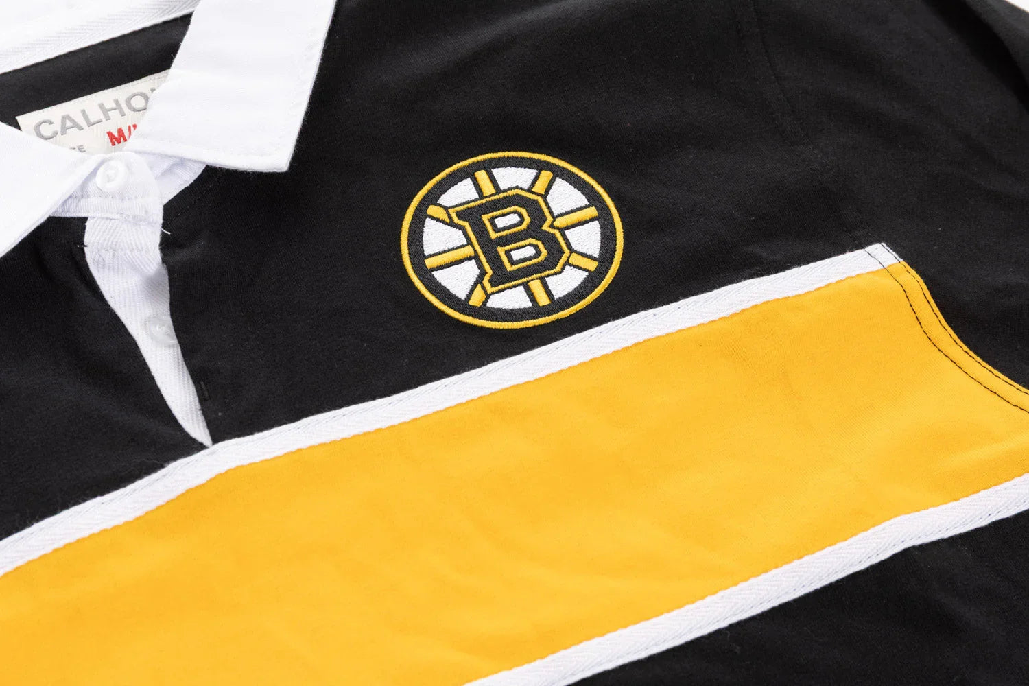 Boston hockey logo embroidered on black and yellow rugby shirt with white collar