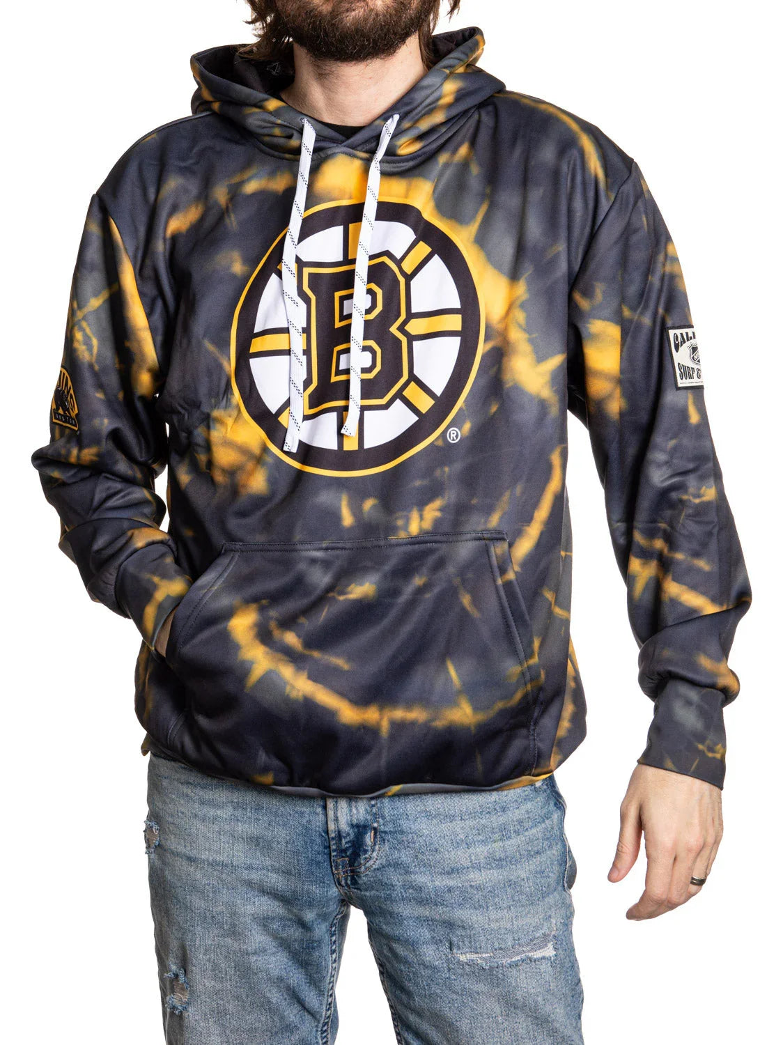 Boston Bruins tie-dye hoodie with large logo, kangaroo pocket, and patches, worn with jeans