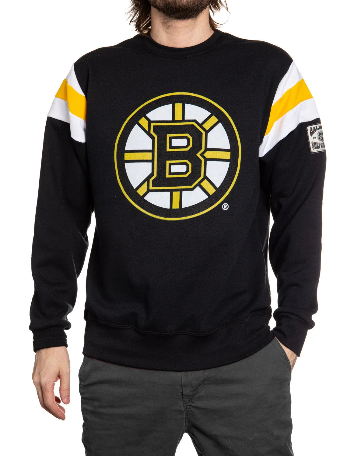 Person wearing black Boston Bruins sweatshirt with yellow and white sleeve stripes