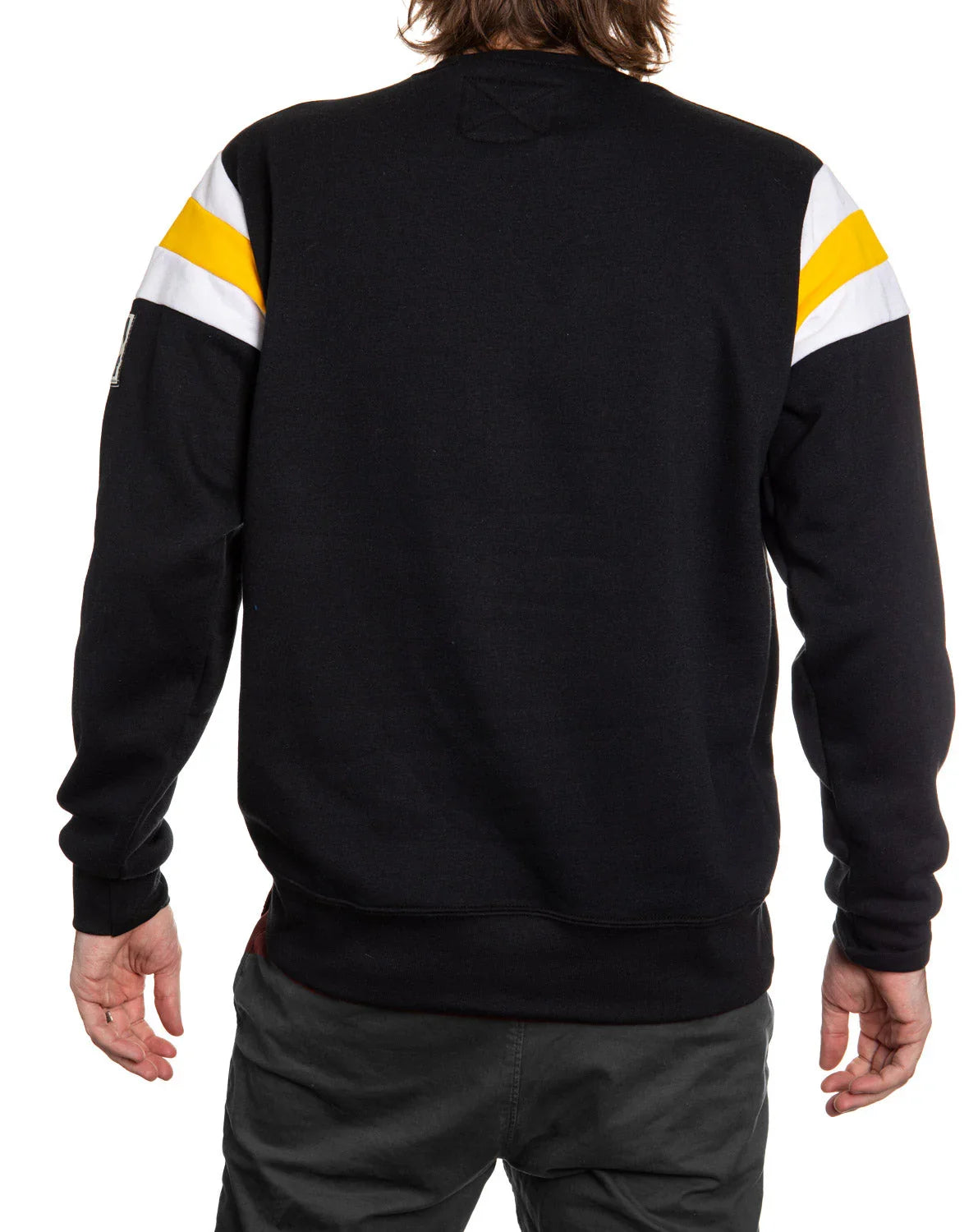 Back view of man wearing black sweatshirt with yellow and white stripes on sleeves