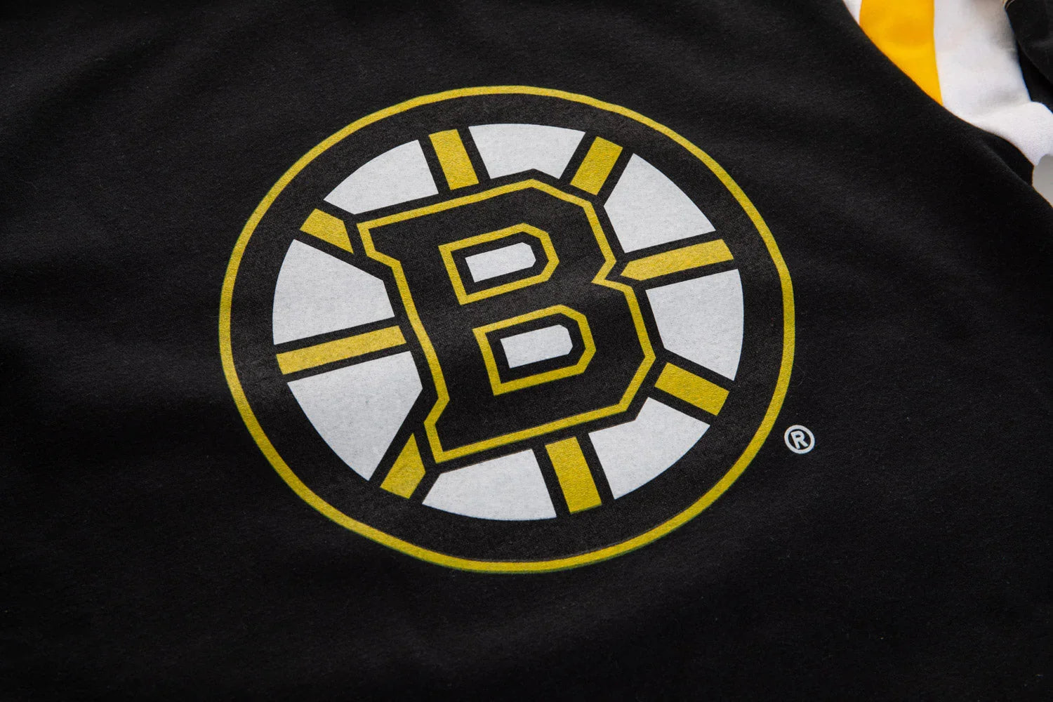 Black shirt with a yellow, black, and white hockey team logo featuring a bold letter B