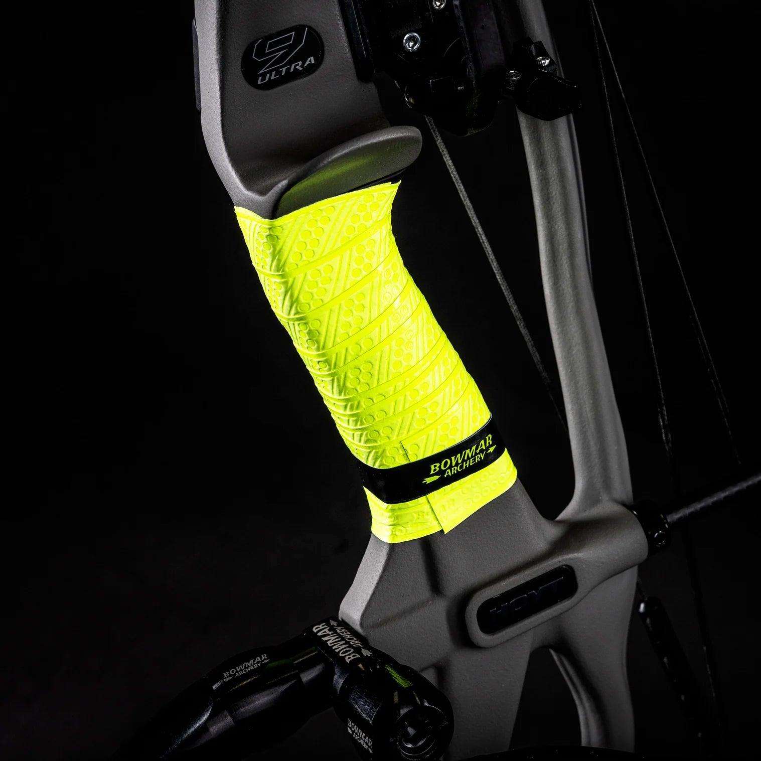 Compound bow with neon yellow Bowmar Archery grip wrap and textured gray riser