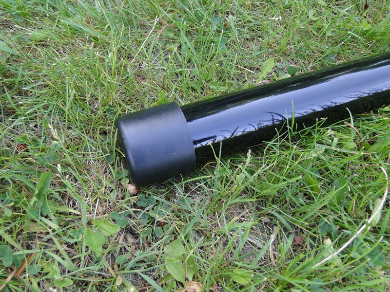 Hammock chair stand foot with black rubber cap on grass outdoors