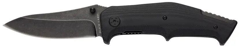 Black folding survival knife with textured handle for outdoor and camping use