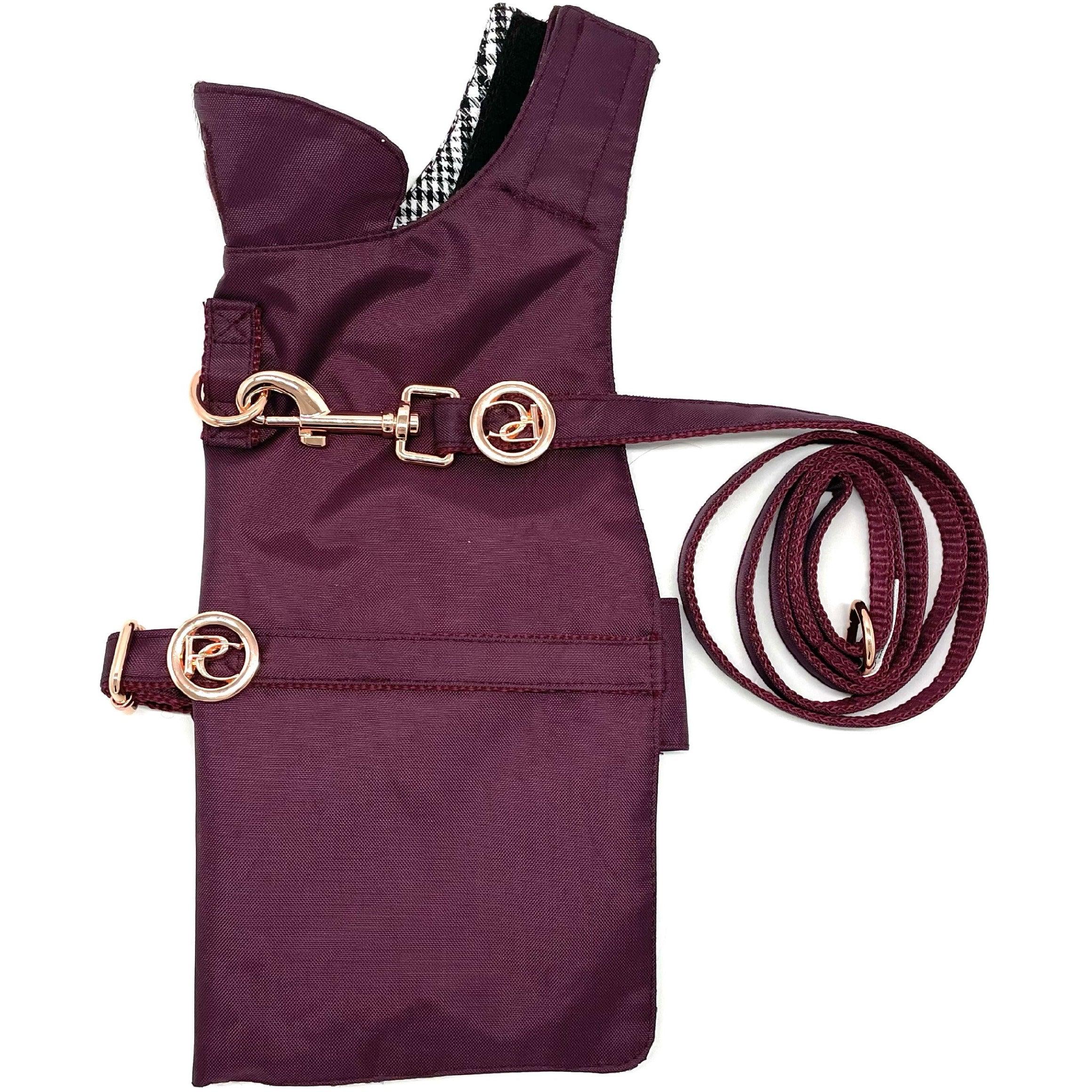 Maroon dog harness vest with matching leash and gold hardware on white background