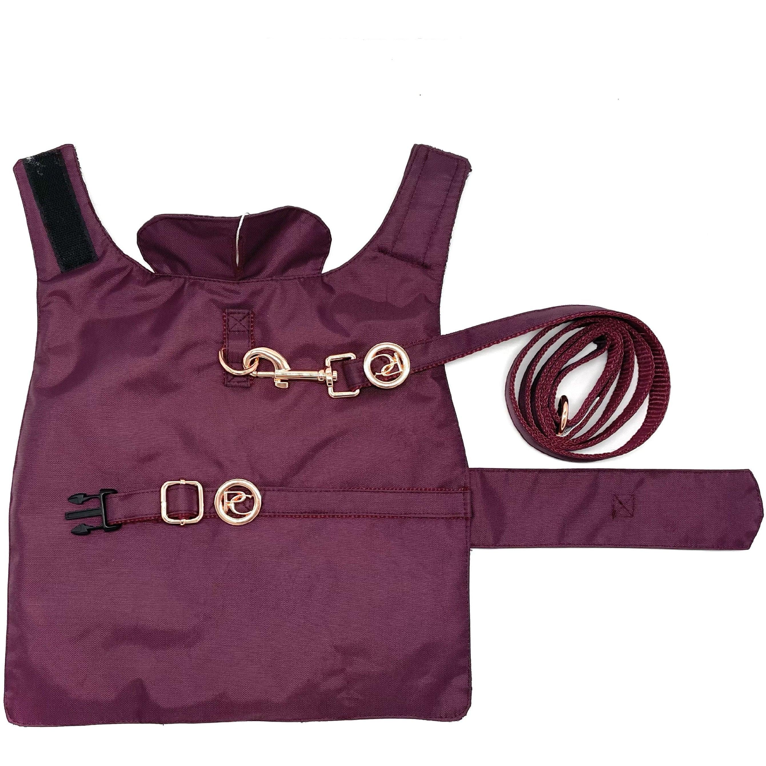 Maroon dog harness and leash set with gold hardware on white background
