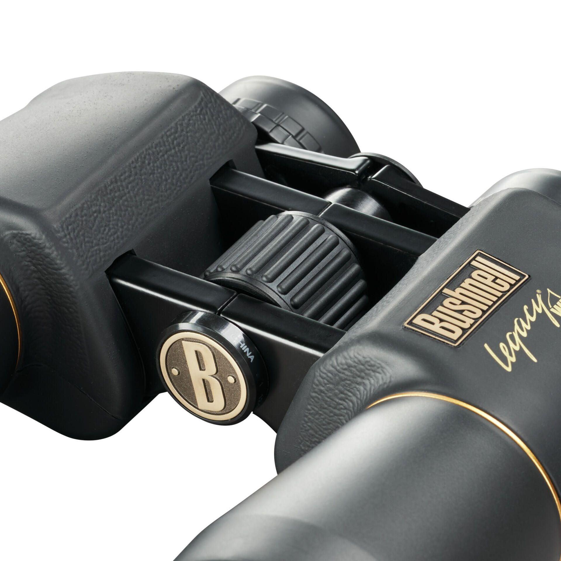 Close-up of Bushnell Legacy WP 10x50 binoculars with textured grip and gold accents