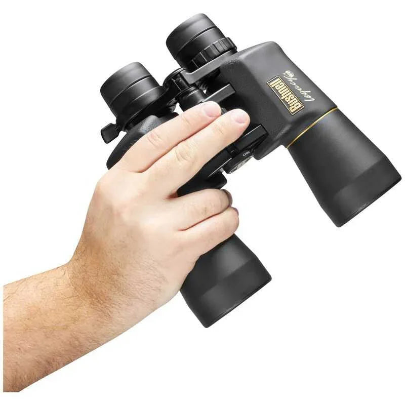 Hand holding Bushnell Legacy WP 10-22x50 binoculars against a white background