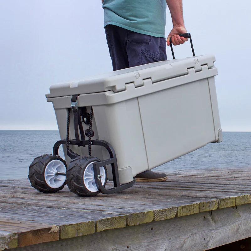 Man pulling large wheeled cooler on dock by lake, portable ice chest for outdoor activities