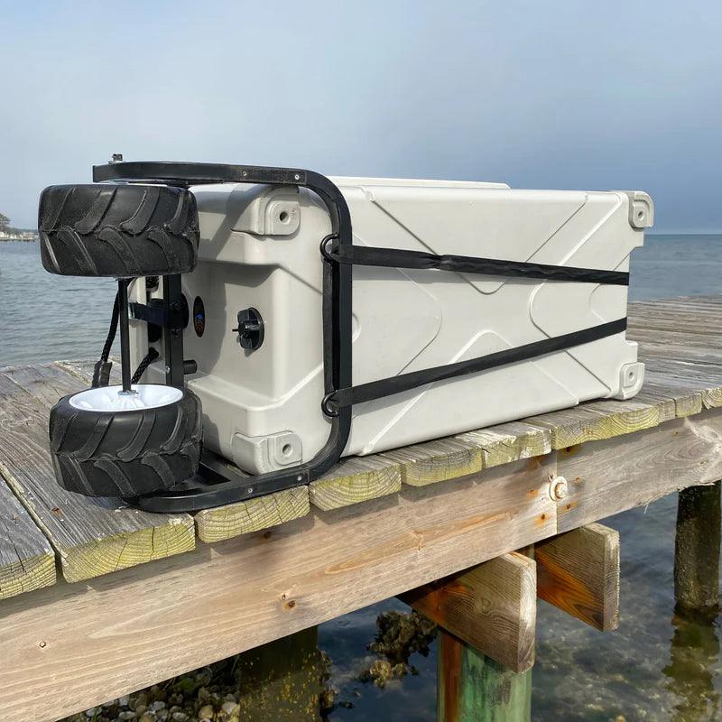 Large wheeled cooler on wooden dock by water, outdoor portable ice chest