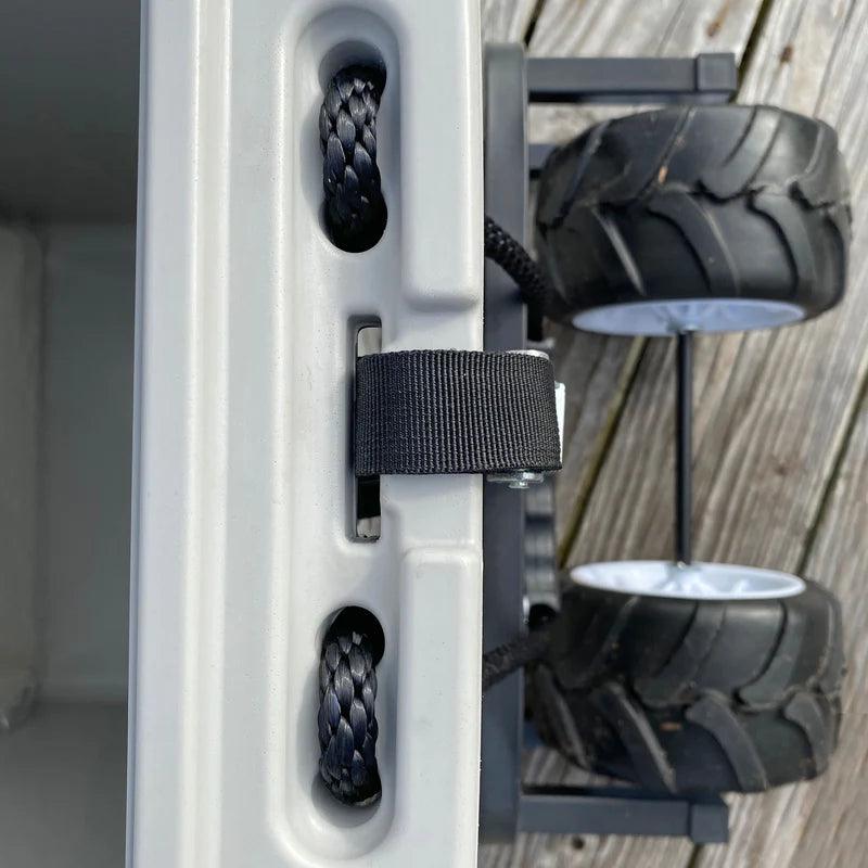 Cooler cart with large rugged wheels, black rope handle, and wood deck background