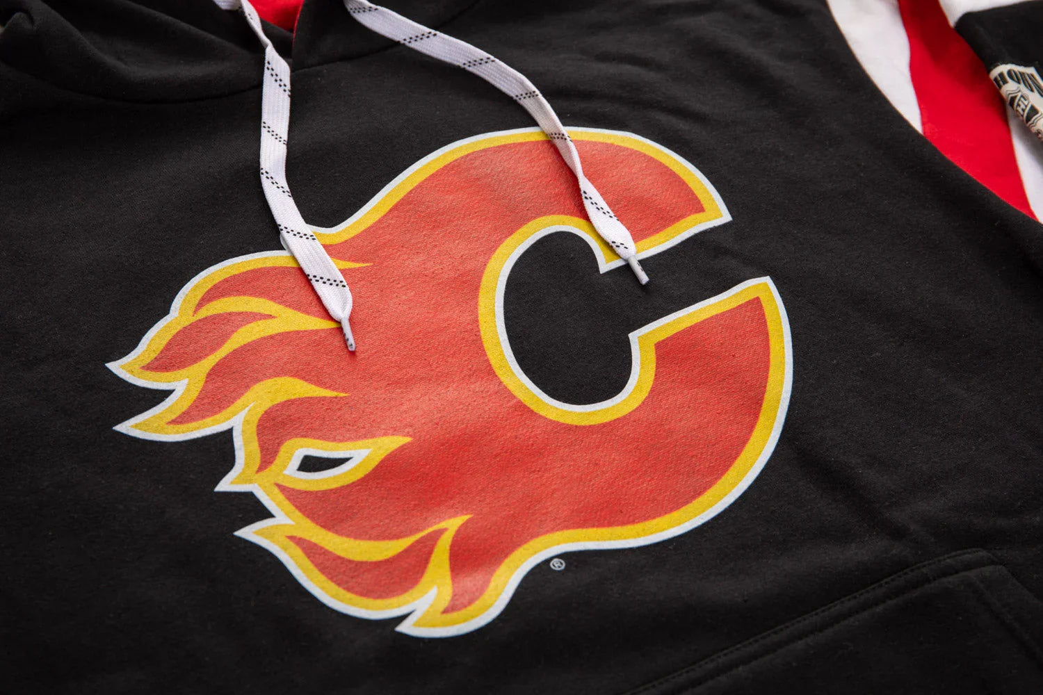 Black hoodie with large flaming red C logo and white drawstrings, sports apparel detail