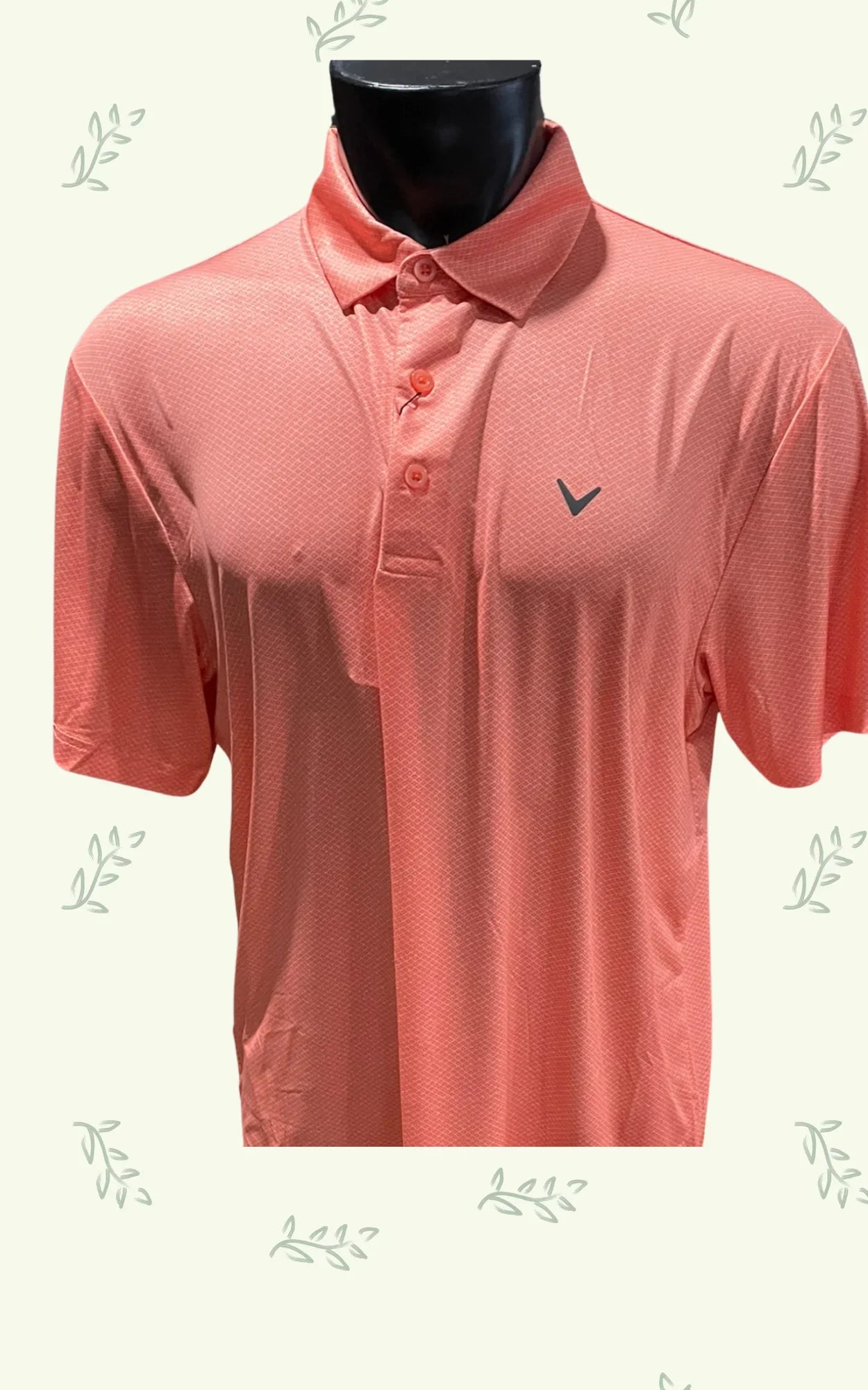Coral pink golf polo shirt with subtle pattern and logo on mannequin, leafy background