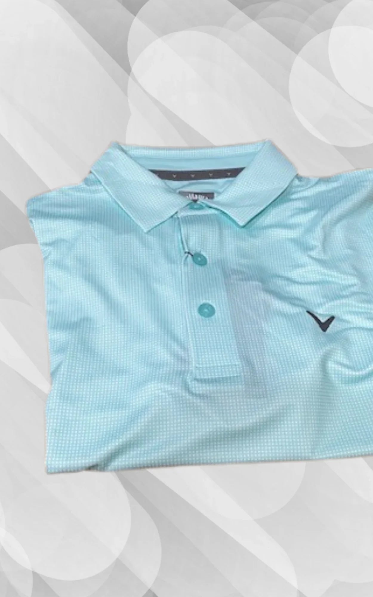 Light blue golf polo shirt with subtle check pattern on geometric background