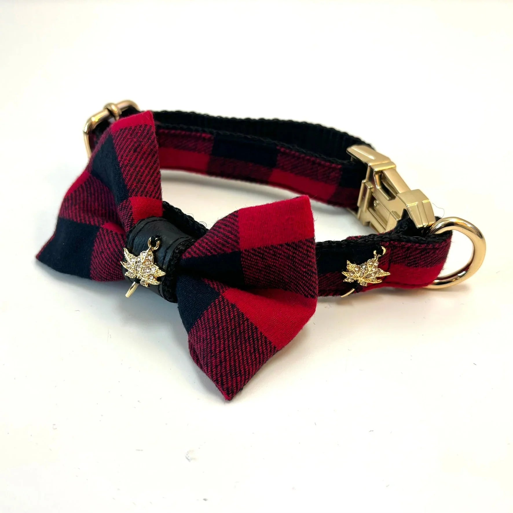 Red and black plaid cat collar with bowtie and gold maple leaf charms on white background
