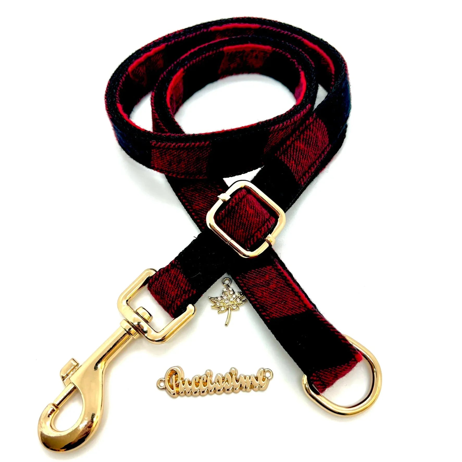 Red and black plaid dog leash with gold hardware on white background