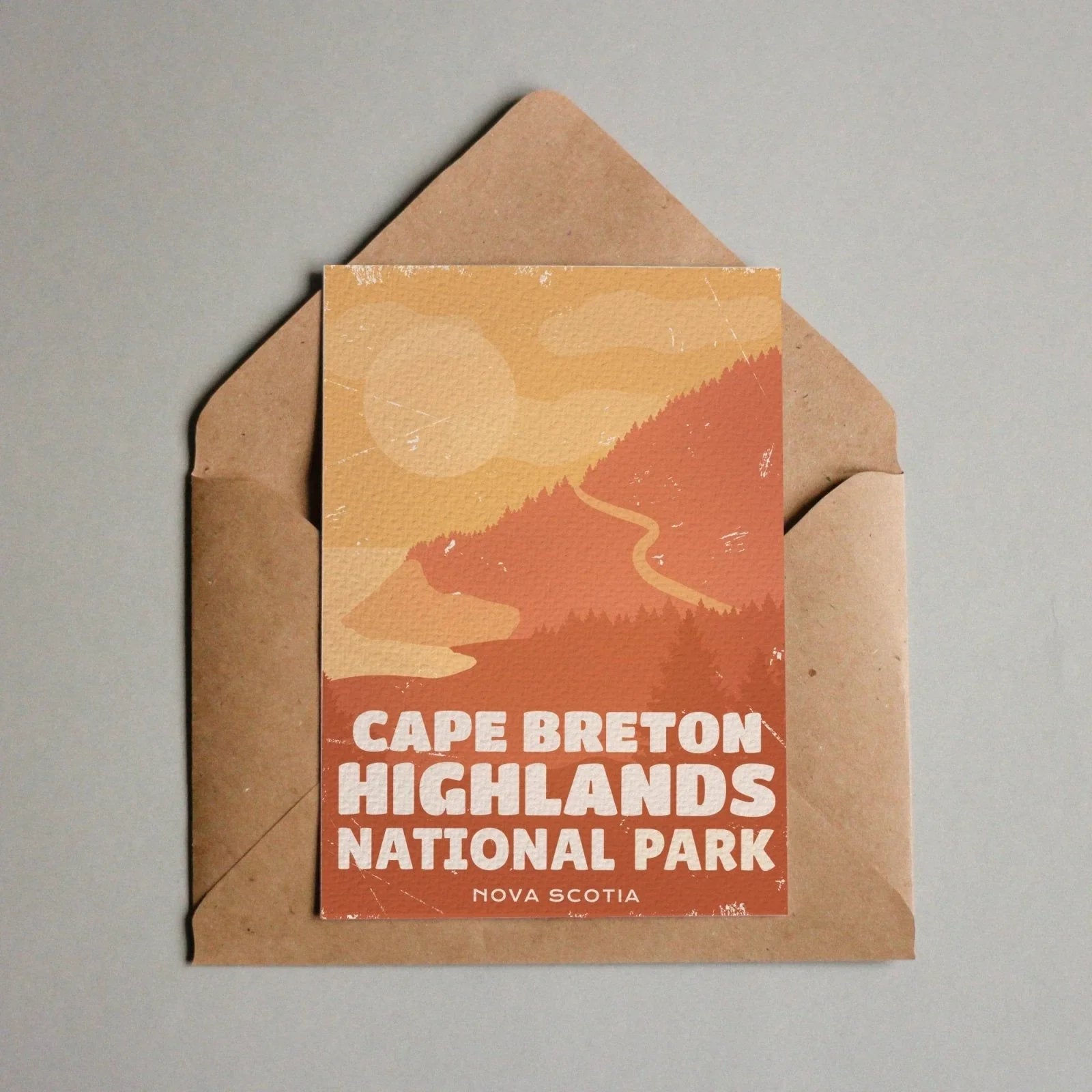 Cape Breton Highlands National Park postcard with stylized mountains, sunrise, and envelope