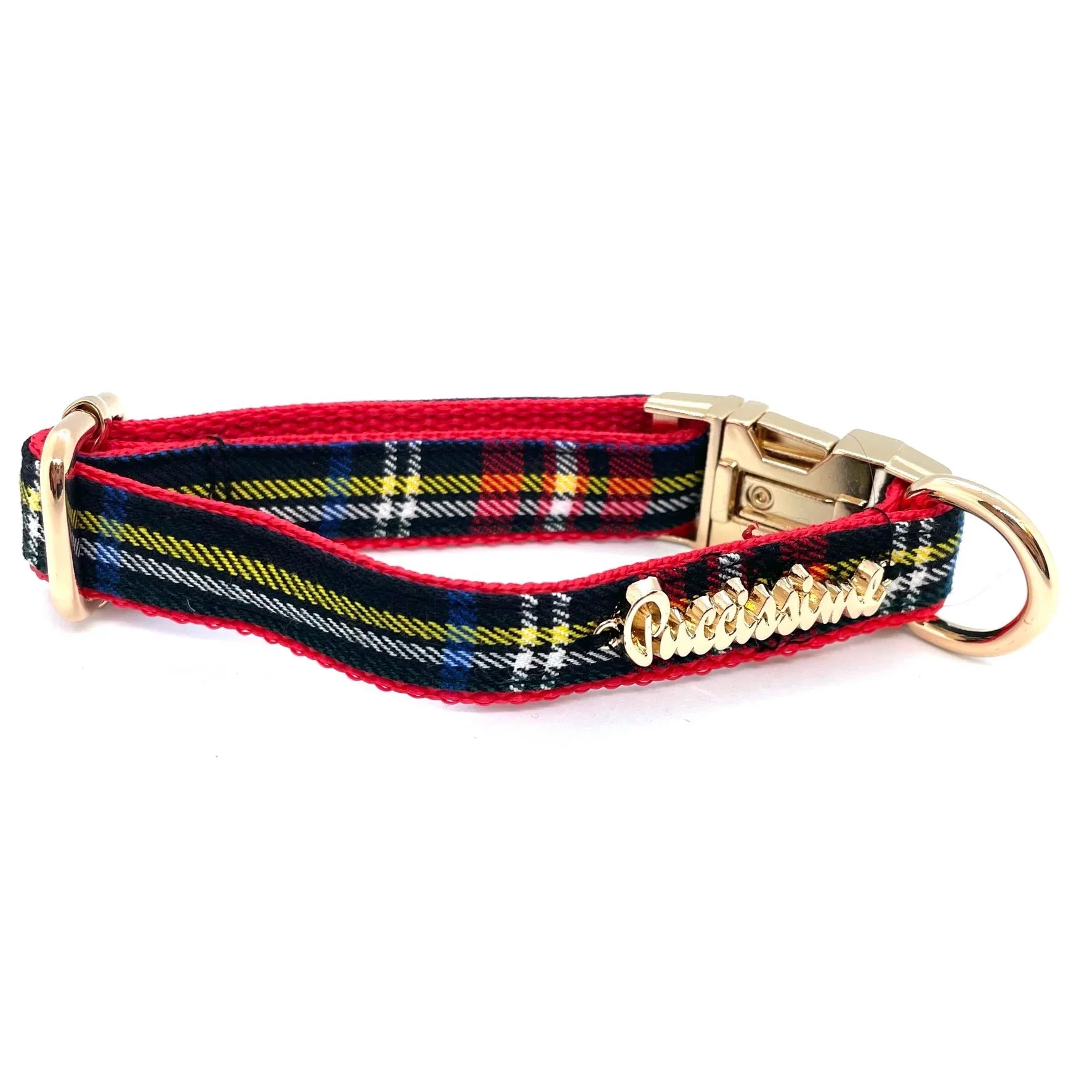 Plaid dog collar with red trim, gold buckle, and Puccissima nameplate on white background