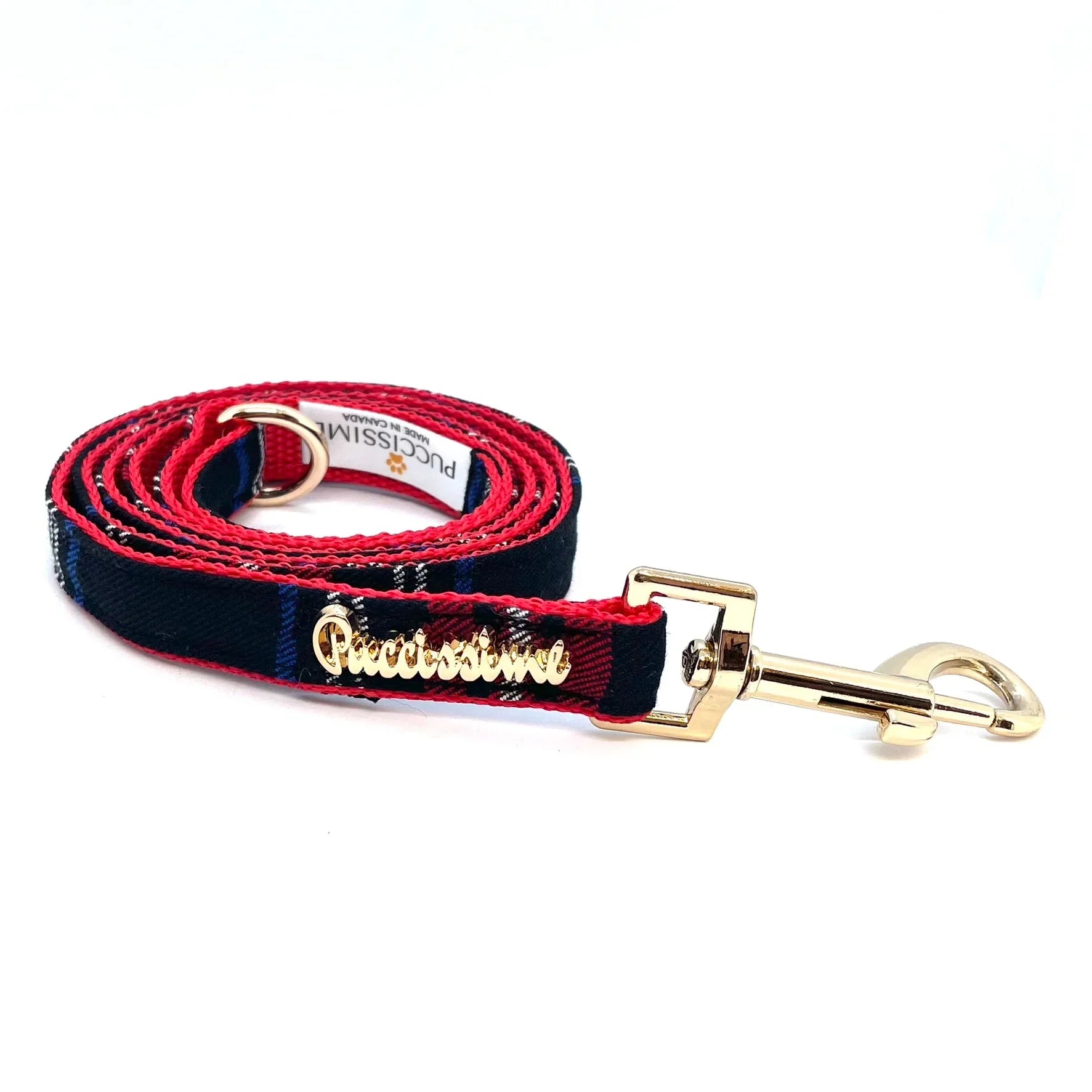 Red and black plaid dog leash with gold hardware and Puccissime branding on white background.