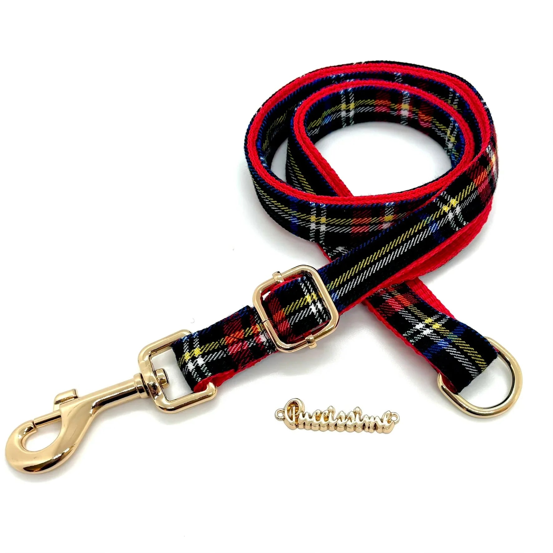 Red and black plaid dog leash with gold hardware on white background