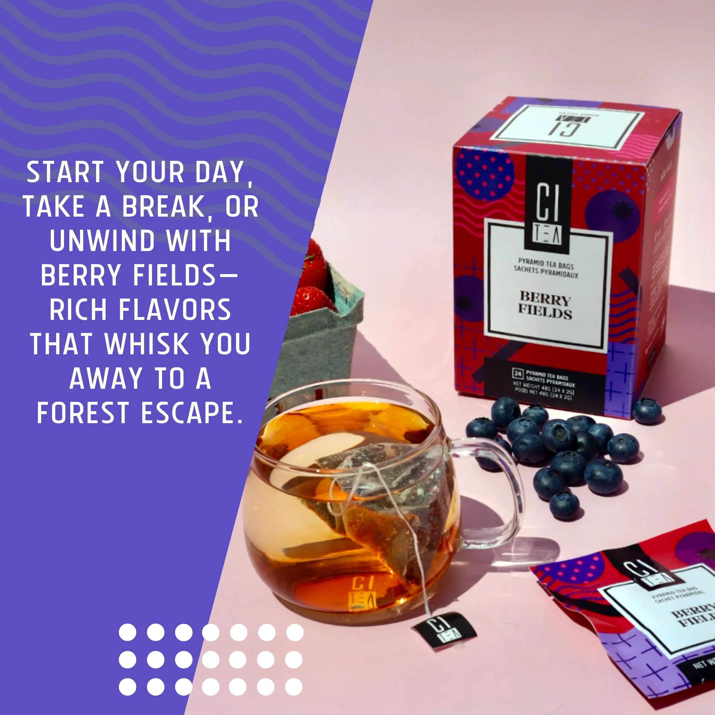 Berry Fields tea box with glass cup of tea, blueberries, and strawberries on a pink surface.