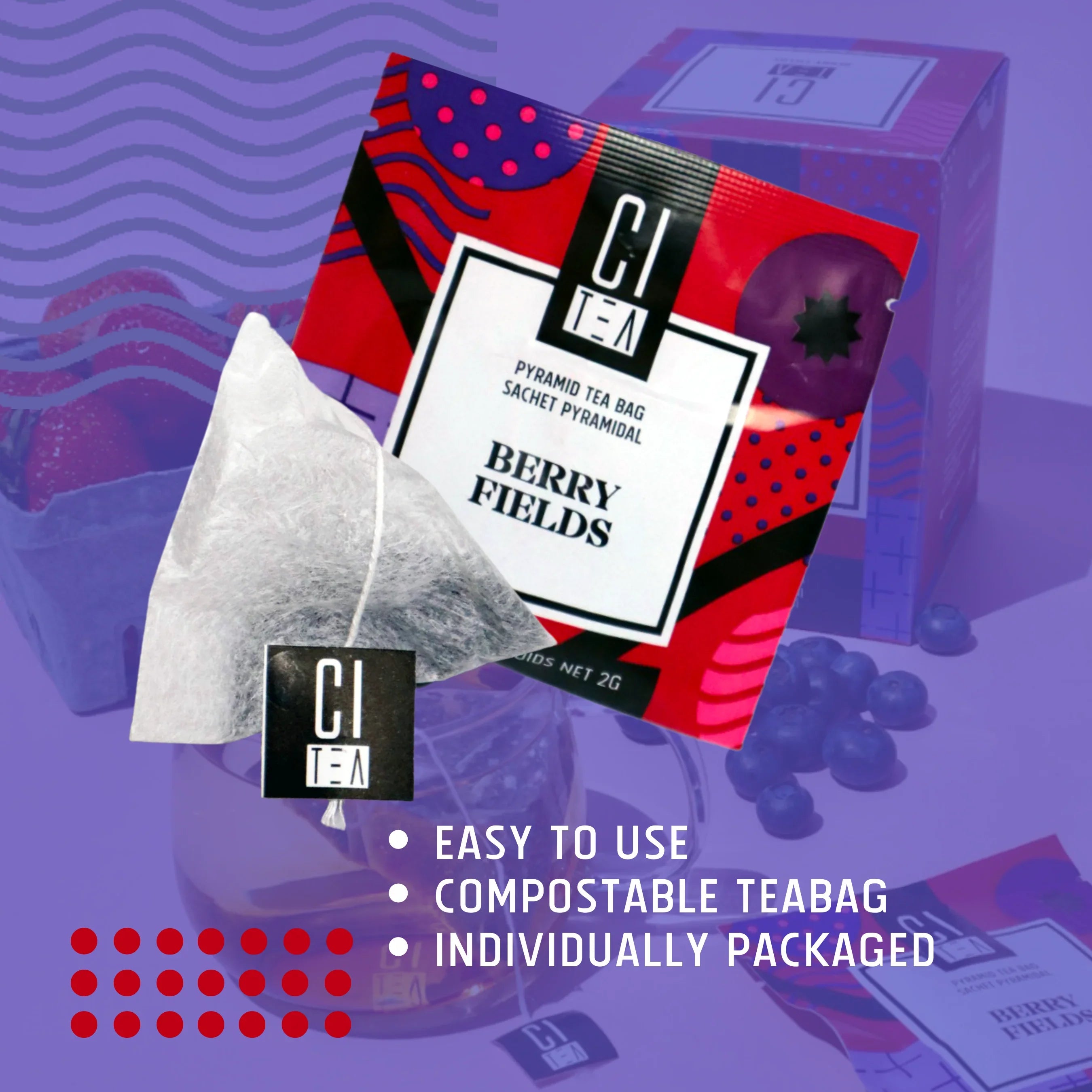 Berry Fields pyramid tea bag and packaging with blueberries and strawberries on purple background