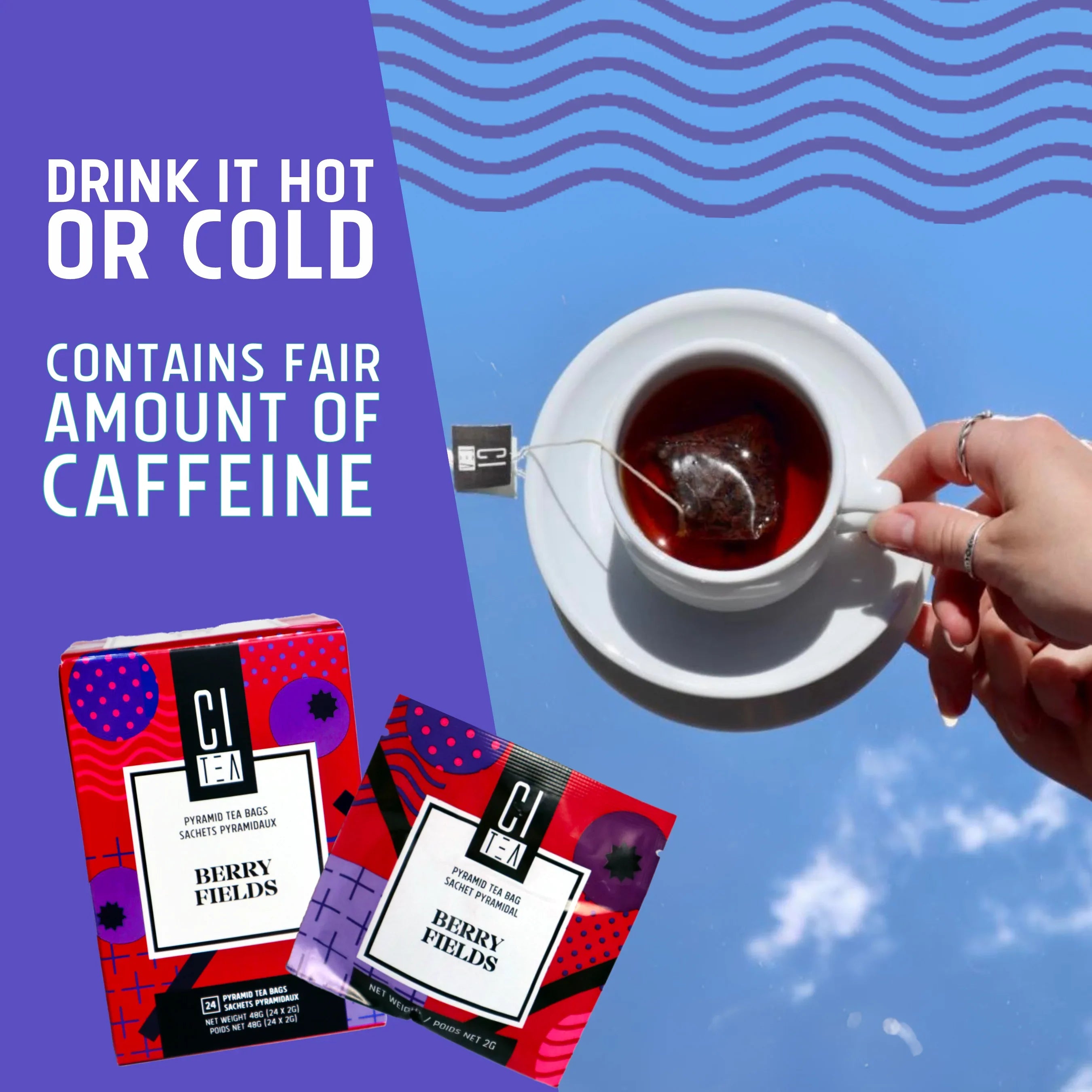 CI Tea Berry Fields tea box and sachet with hand holding cup of hot tea against blue sky.